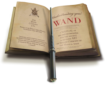 Kymera Magic wand laying across an ancient, magical book